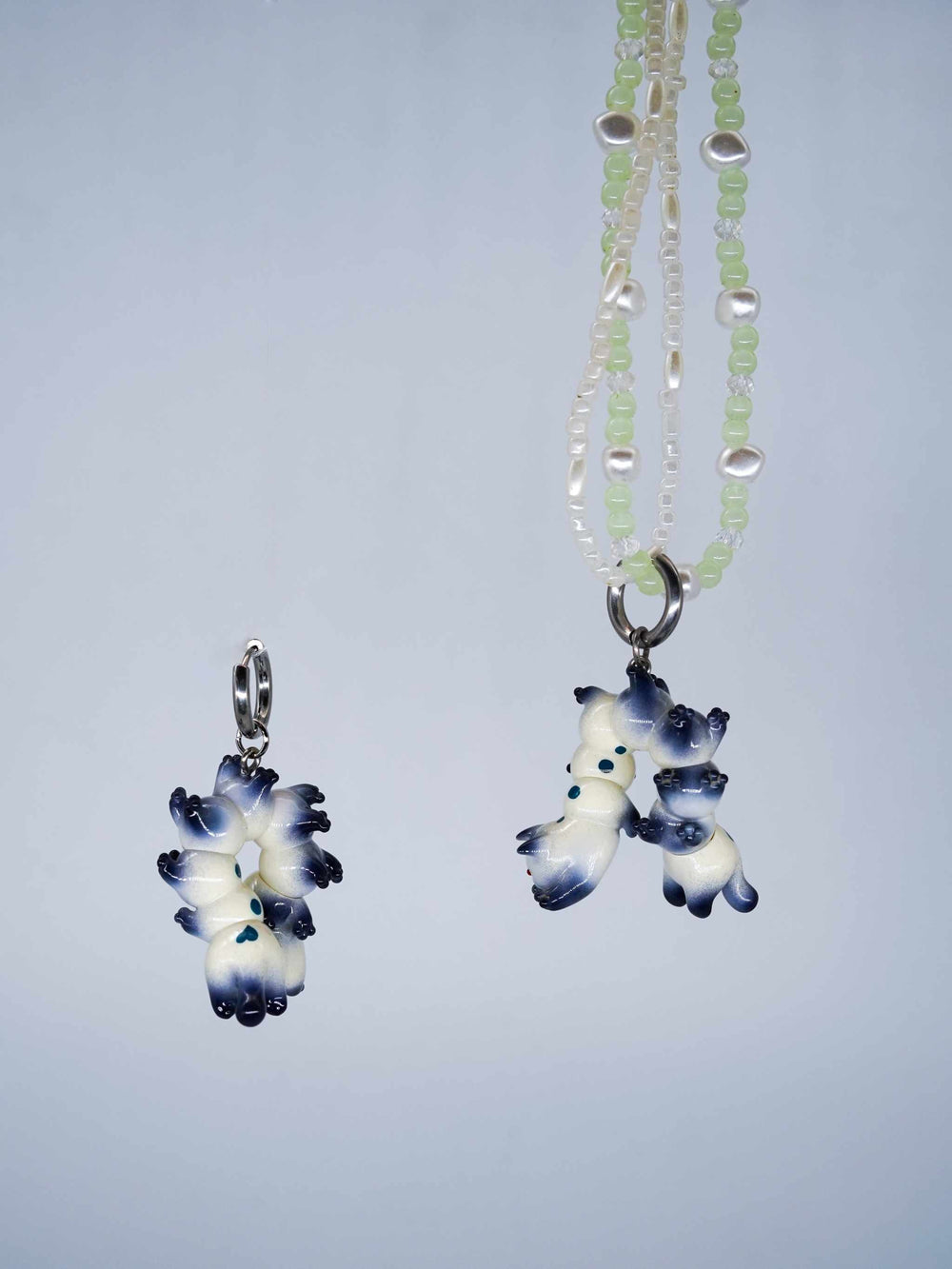 Seal point cat caterpillar necklace and earring set with porcelain-like design and jade beads.