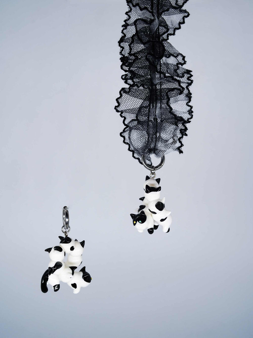Tuxedo cat caterpillar necklace and earring with lace and metal detailing.