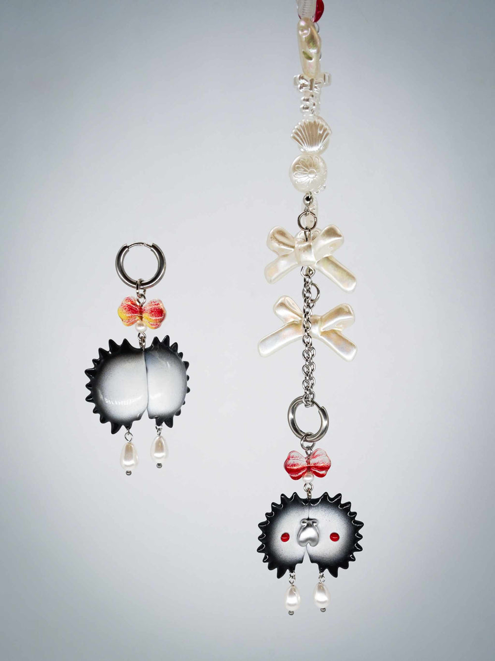 Venus flytrap necklace and earrings with black edge, silver fly, watermelon red and powder blue design.