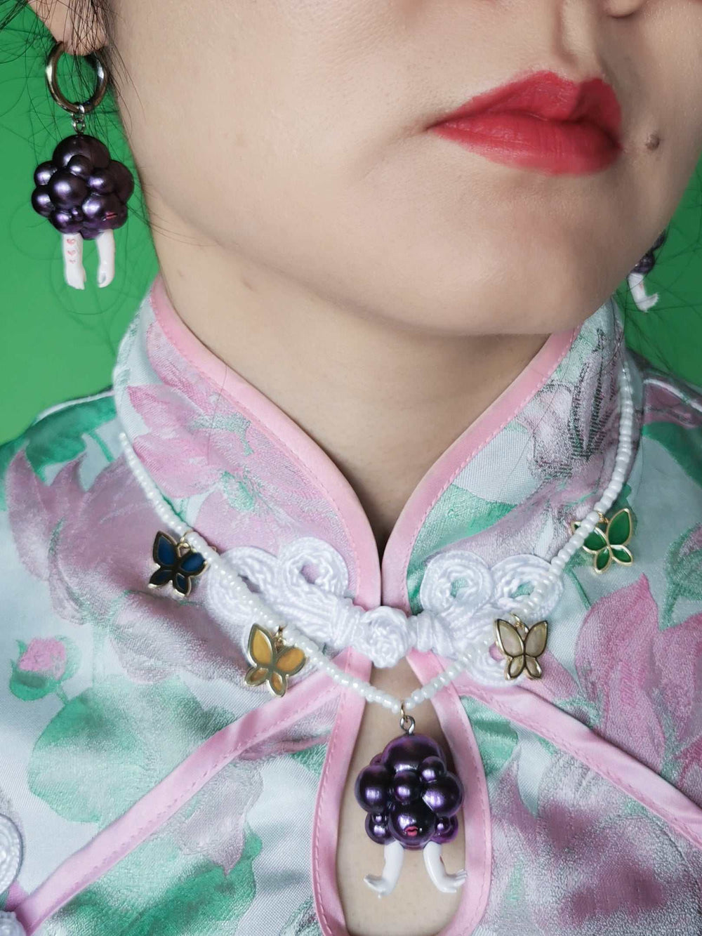 Grape head double-faced girl necklace and earring set in metallic purple with happy and moody expressions
