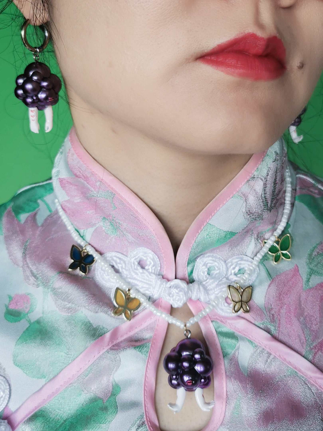 Grape head double-faced girl necklace and earring set in metallic purple with happy and moody expressions