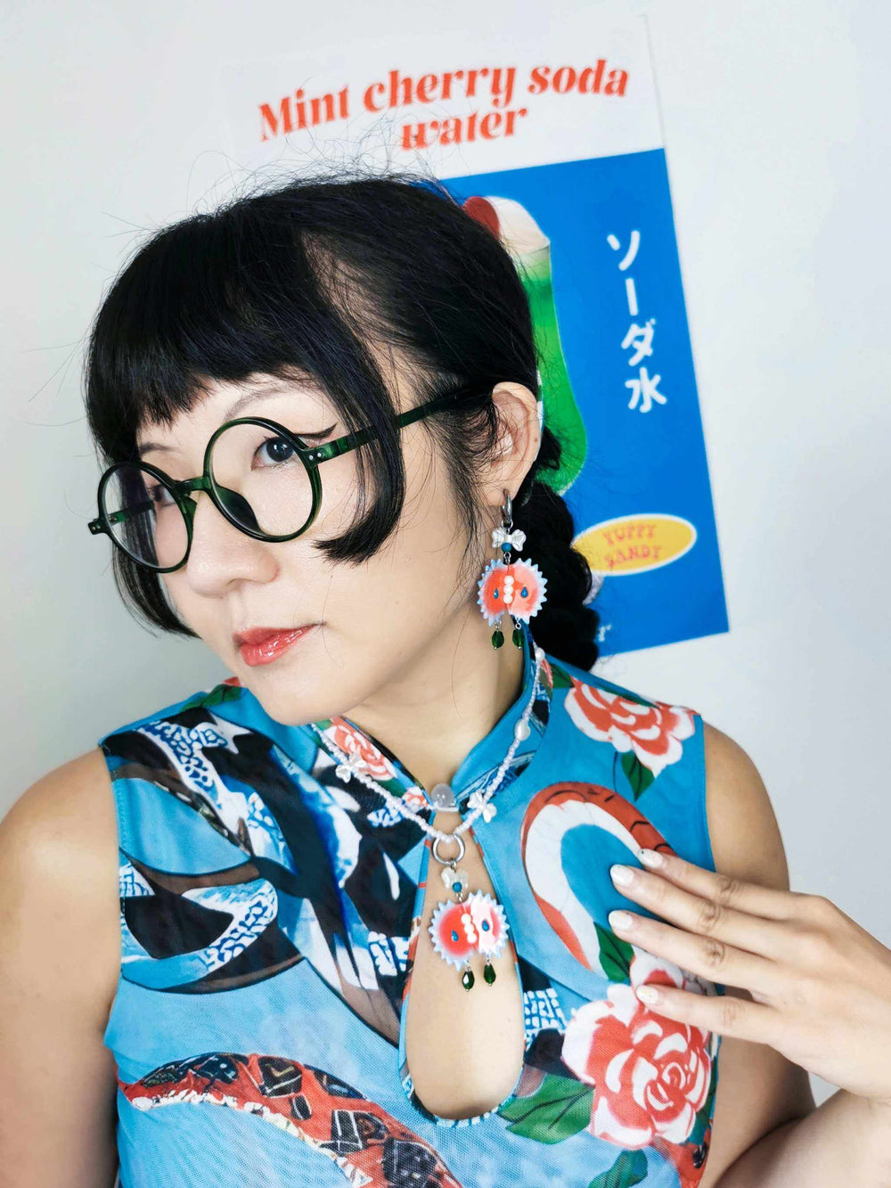 Venus flytrap necklace and earrings with blue edge and pearl center, worn with ornate dress.
