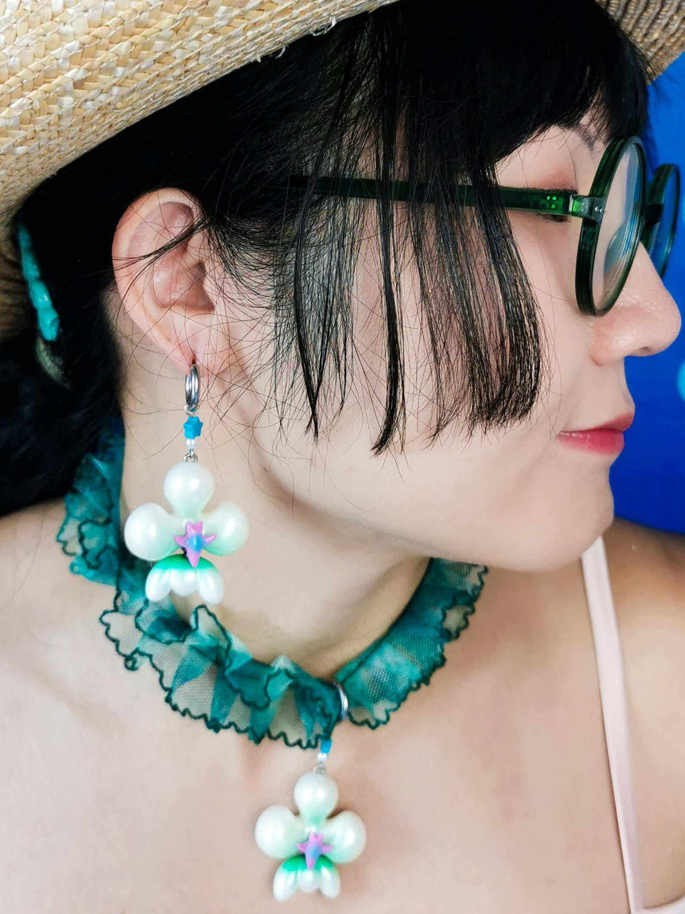 Butterfly orchid necklace and earring set with pearl white and green accents.