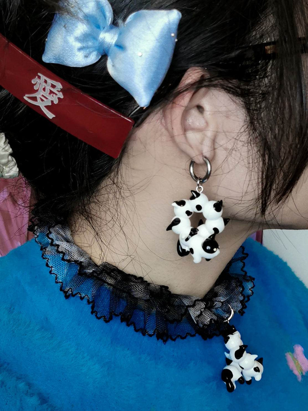 Tuxedo cat-themed necklace and earrings with caterpillar design.