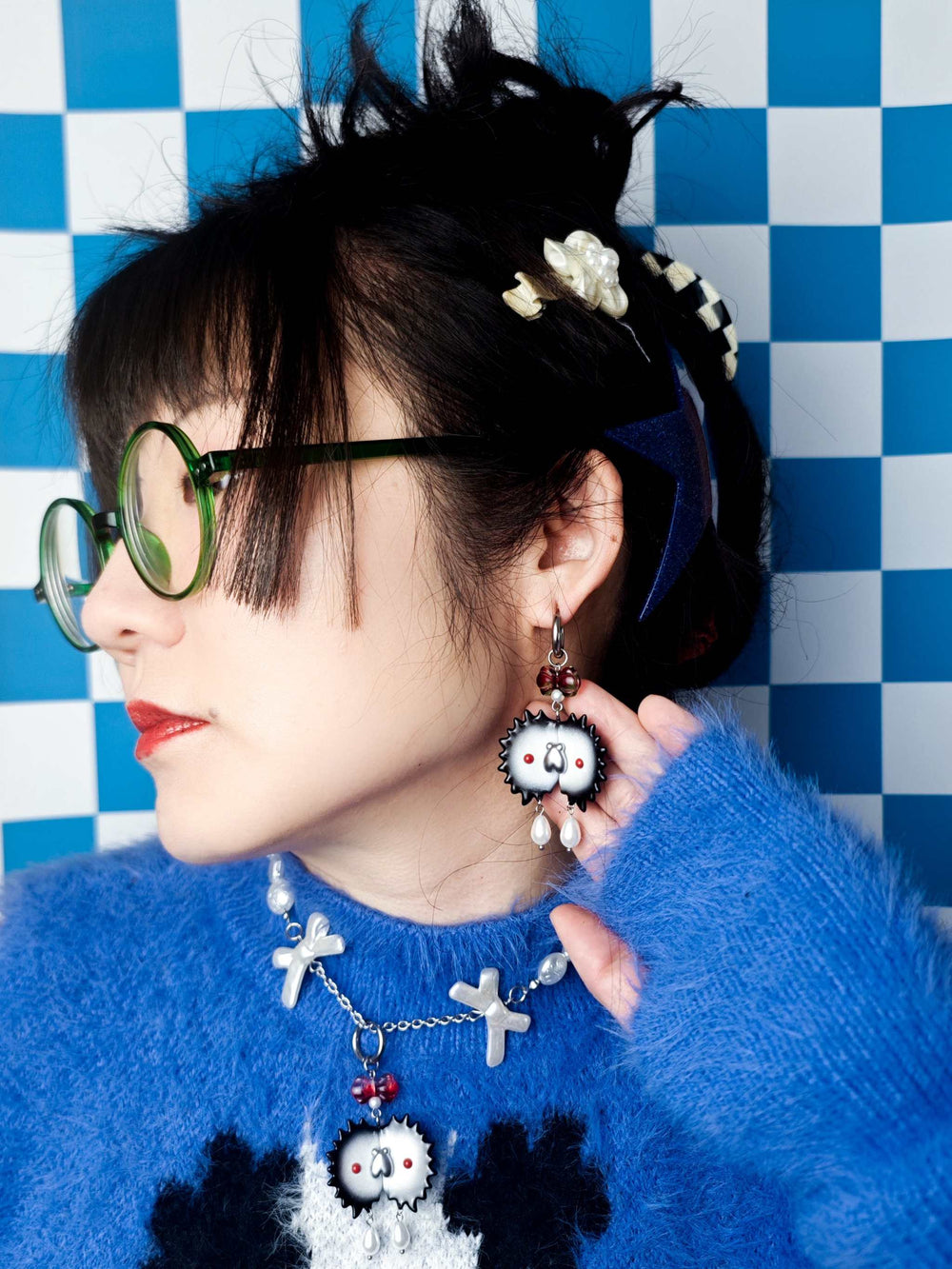 Venus flytrap necklace and earring set with black edge and silver fly, whimsical jewelry collection with black, white, red, and silver design.