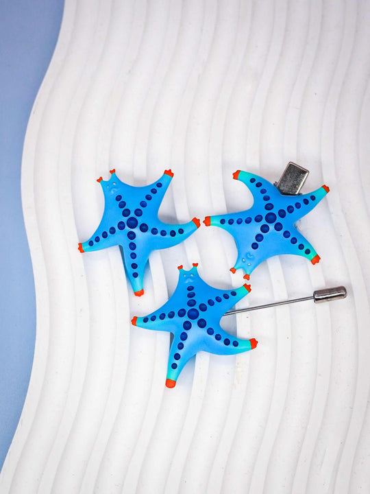 SeaStar cat hairclip and brooch set in blue and orange, polyurethane resin and titanium steel, whimsical cat star design.