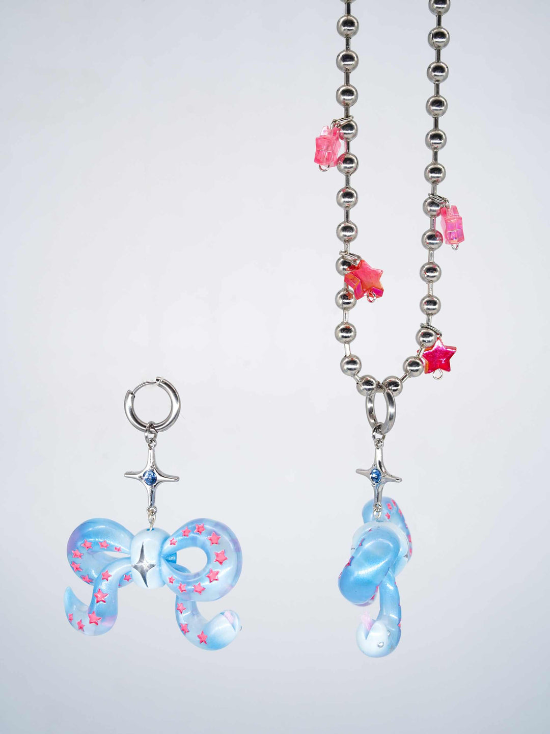 Ice blue snake bowtie necklace and earring with pink star accents and ball chain necklace