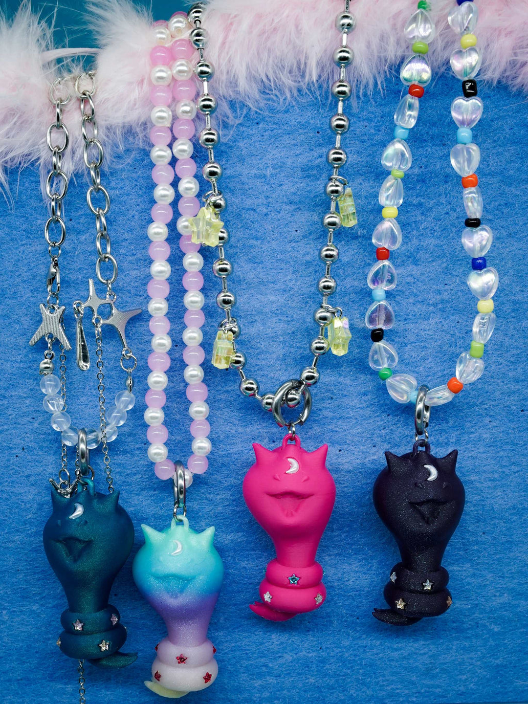 Cat Snake necklace, earring, and bag charm with diamond star accents in surreal cat-cobra design