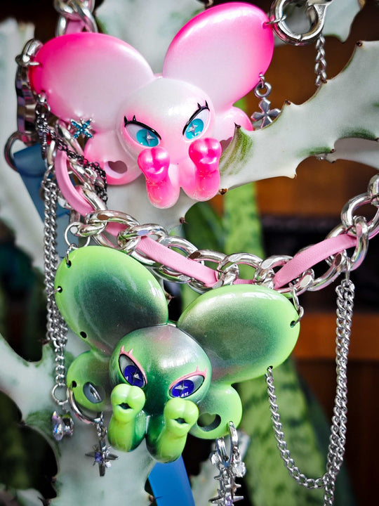 Twin-Trunk Diva Elephant Necklace in alien apple green with two trunks and starry eyes