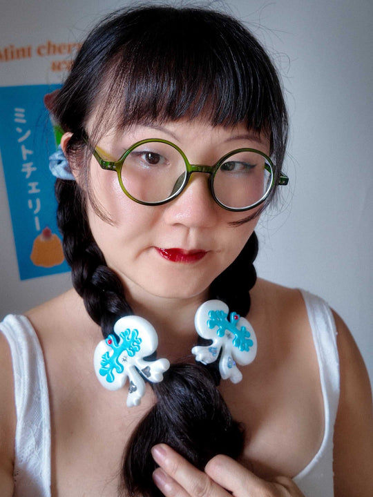3D printed lung-shaped bow hair clip with rhinestone details in white and green colorway