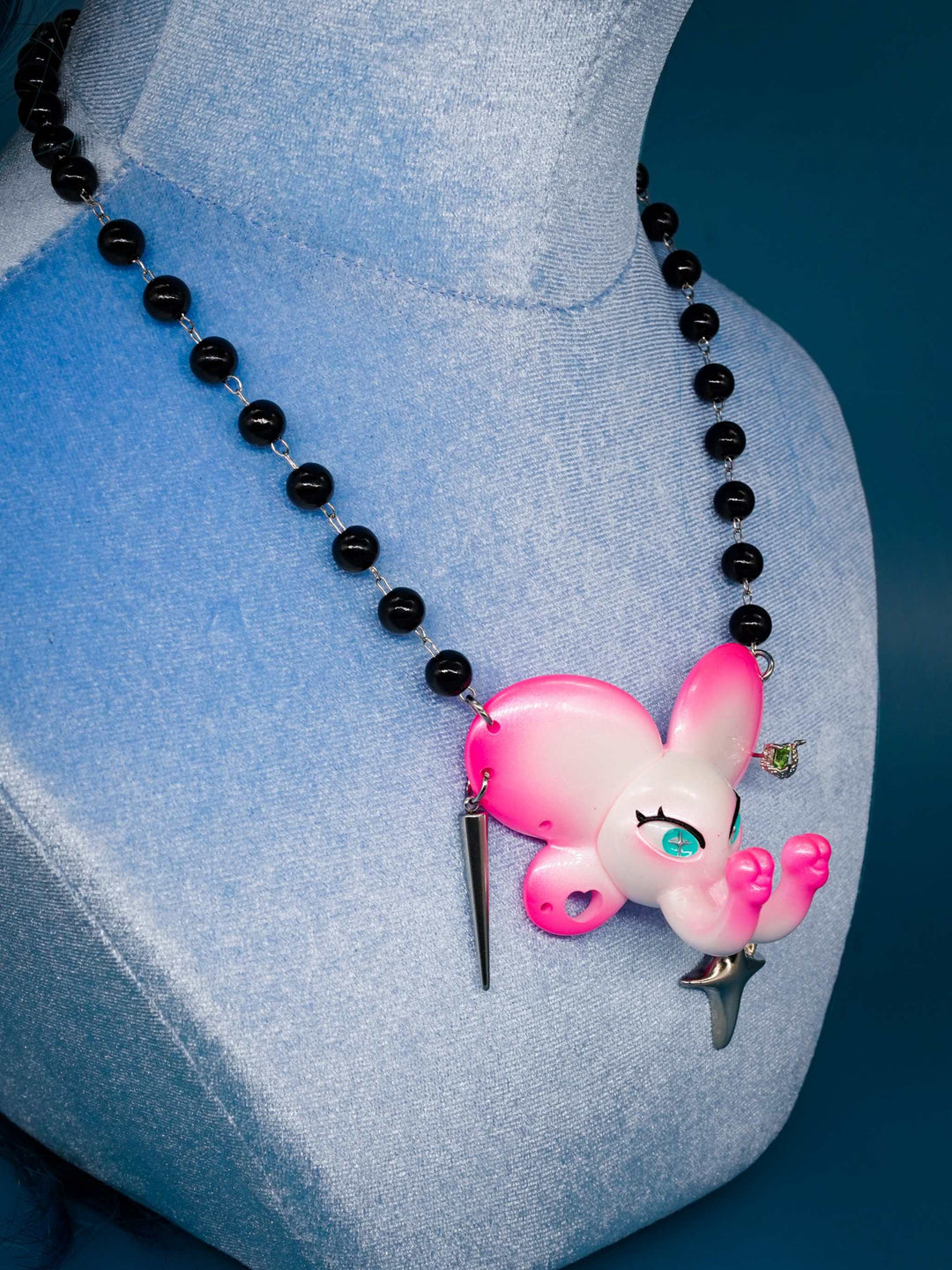 Twin-Trunk Diva Elephant Necklace in pink pearl white with two trunks and sparkling blue-green eyes