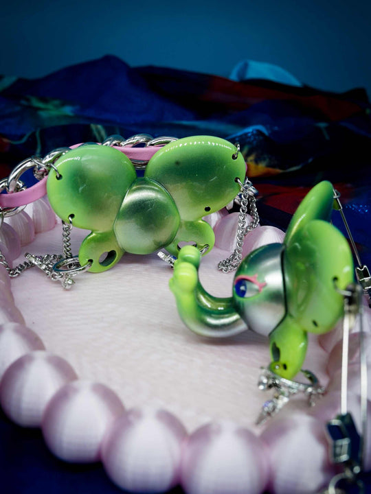 Twin-Trunk Diva Elephant Necklace in metallic alien apple green with two trunks and starry eyes