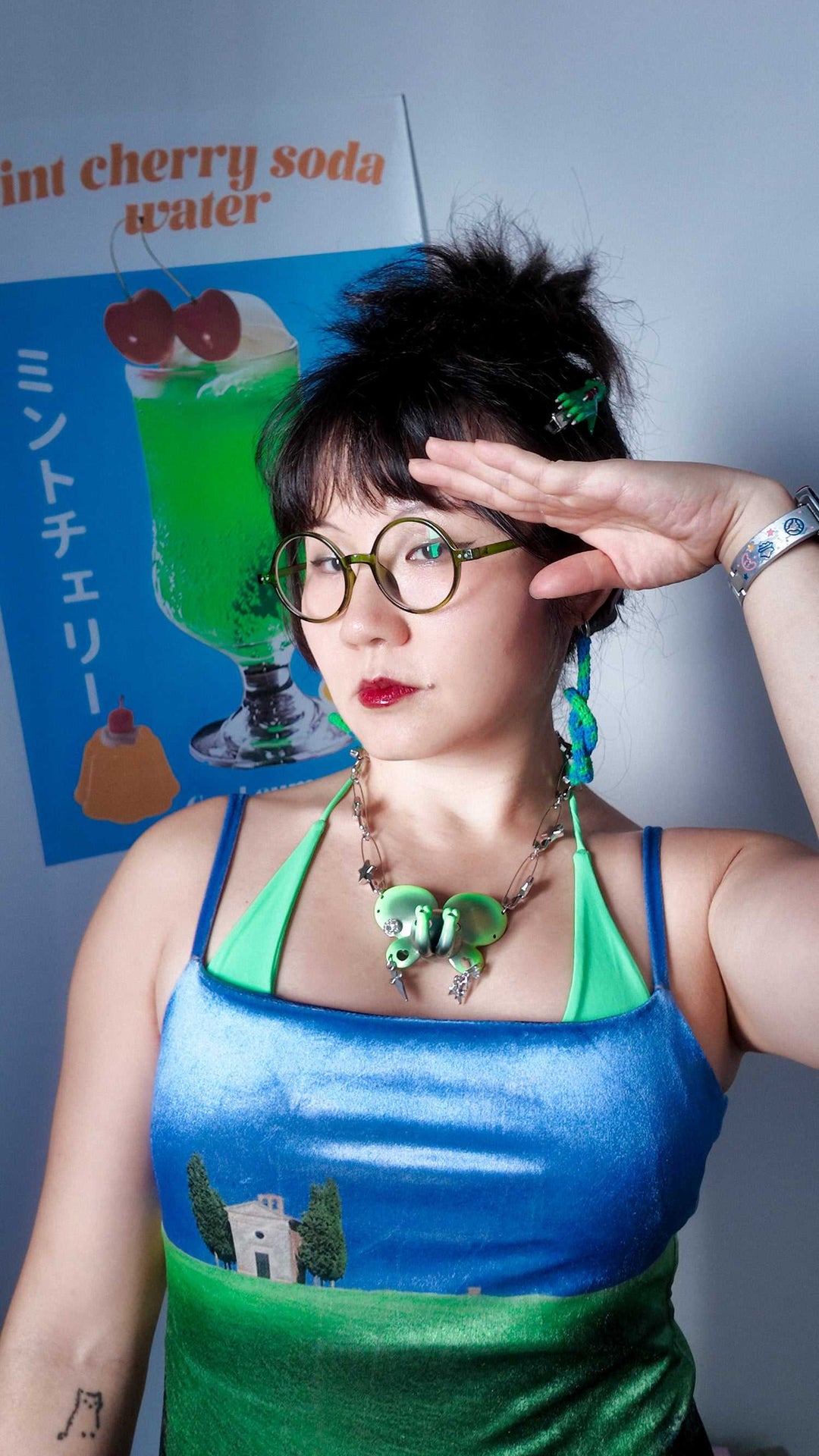 Twin-Trunk Diva Elephant Necklace in metallic alien apple green with two trunks, pink lashes, and starry blue-purple eyes
