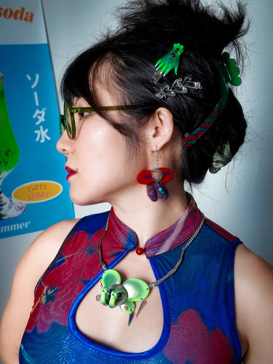 Twin-Trunk Diva Elephant Necklace in alien apple green with two trunks and starry eyes