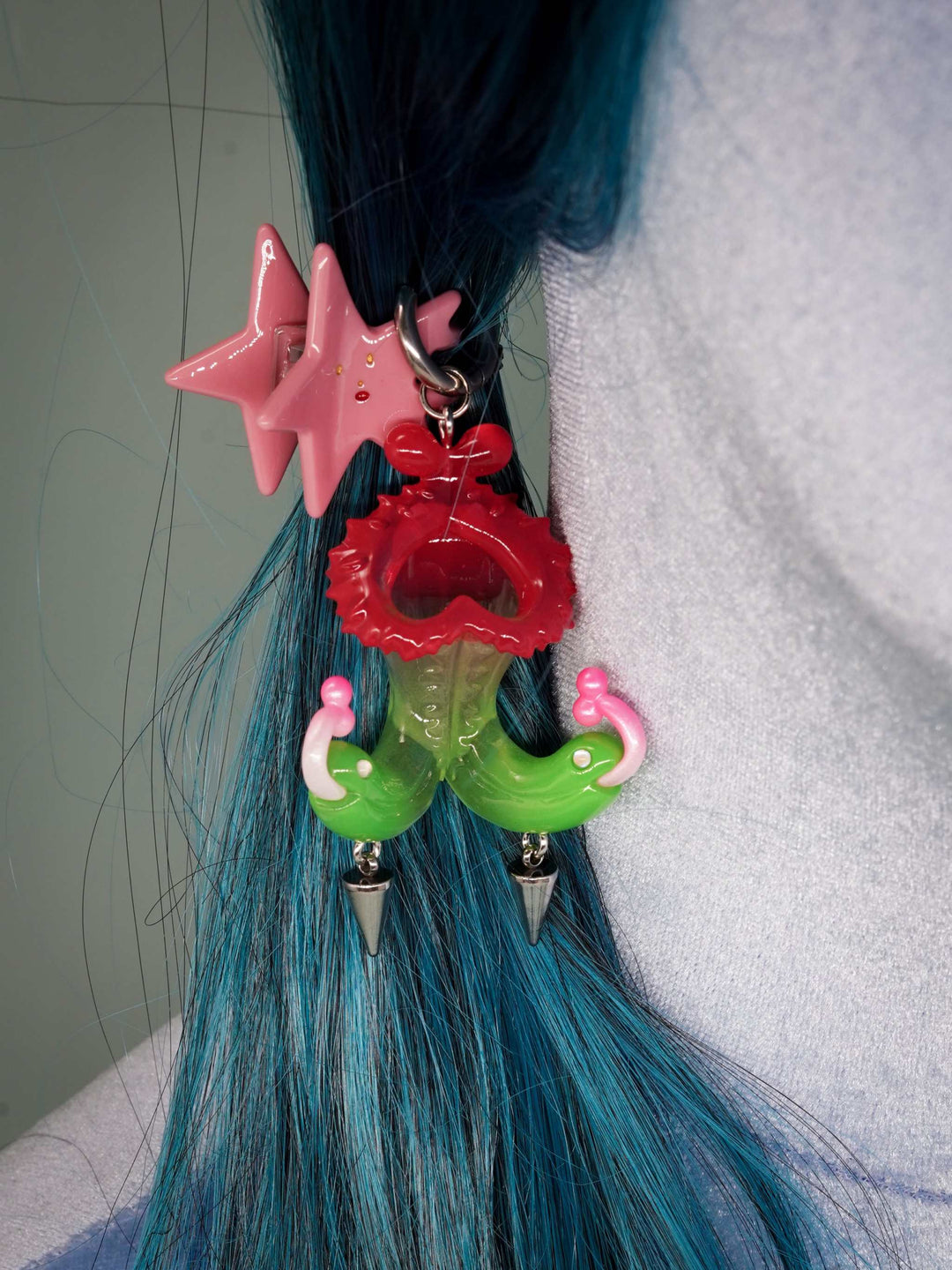 Twin-headed pitcher serpent earrings in translucent red, green, and pink with metal spikes by Acid Candy