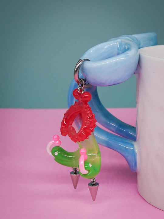 Twin-headed pitcher serpent earrings with cherry red and acid green colors, featuring serpent heads and metal spikes