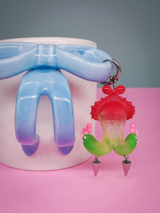 Twin-headed pitcher serpent earrings in translucent cherry red and acid green with metal spikes by Acid Candy