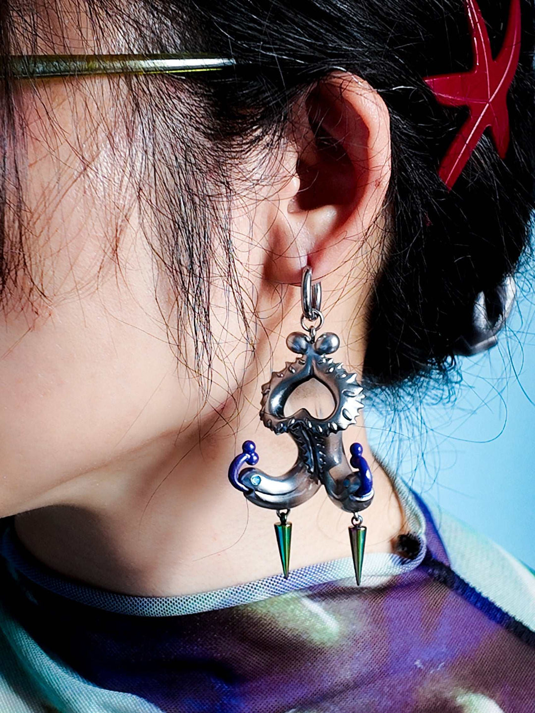 Twin-Headed Pitcher Serpent Earrings with violet tendrils and metallic spikes inspired by pitcher plant shapes