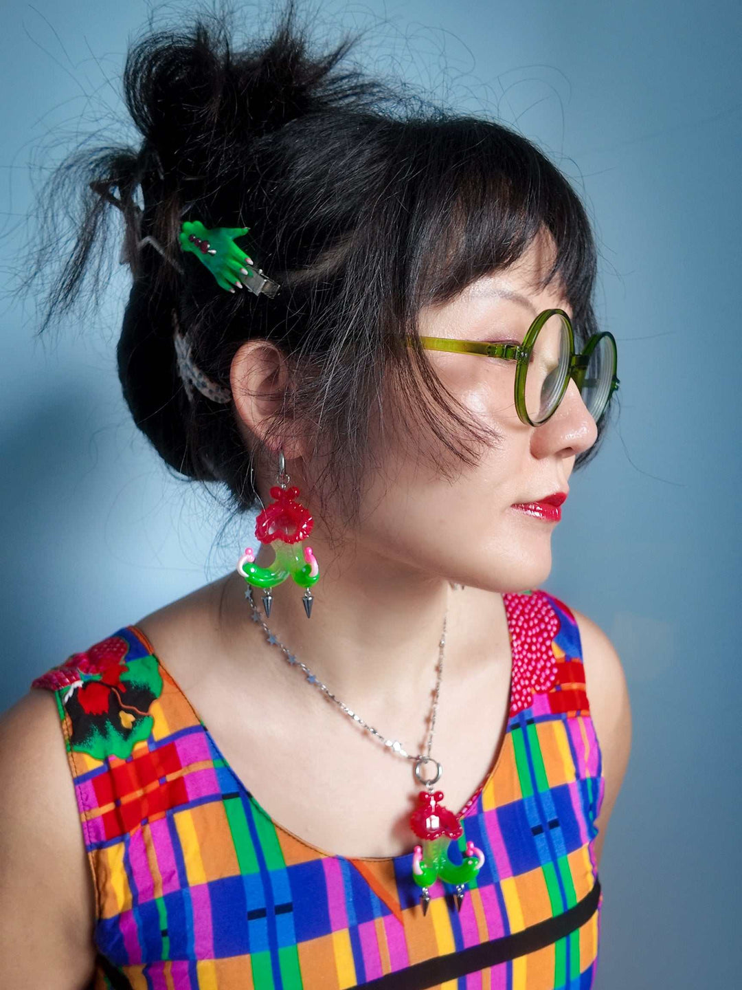 Twin-headed pitcher serpent earrings in cherry red, green, and pink with metal spikes by Acid Candy