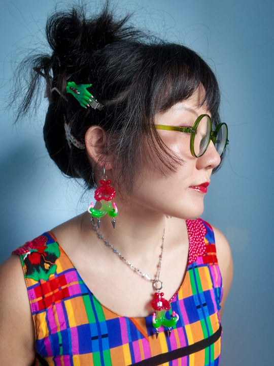 Twin-headed pitcher serpent earrings in cherry red, green, and pink with metal spikes by Acid Candy