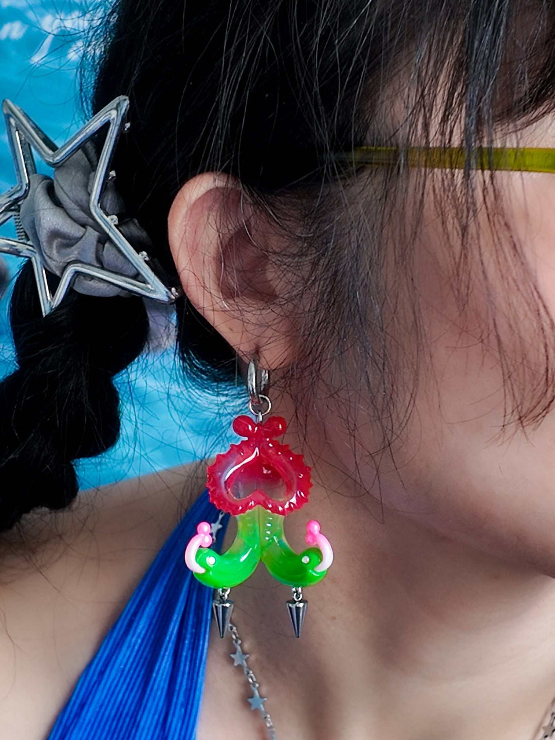 Twin-headed pitcher serpent earrings in red, green, and pink with metal spikes inspired by carnivorous plants