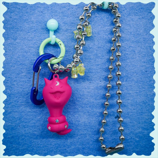 Cat Snake necklace, earring, and bag charm with tiny diamond stars and surreal feline-cobra design