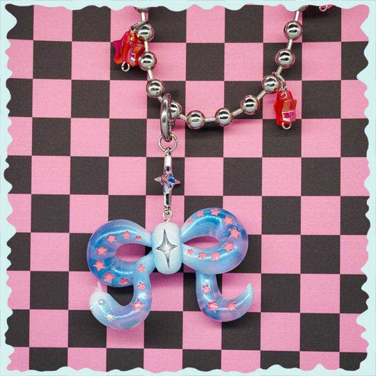 Ice blue snake bowtie necklace with pink stars and felt tongue on beaded chain