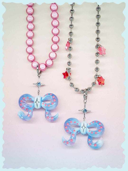 Ice blue snake bowtie necklace and earring set with pink star accents and playful felt tongue