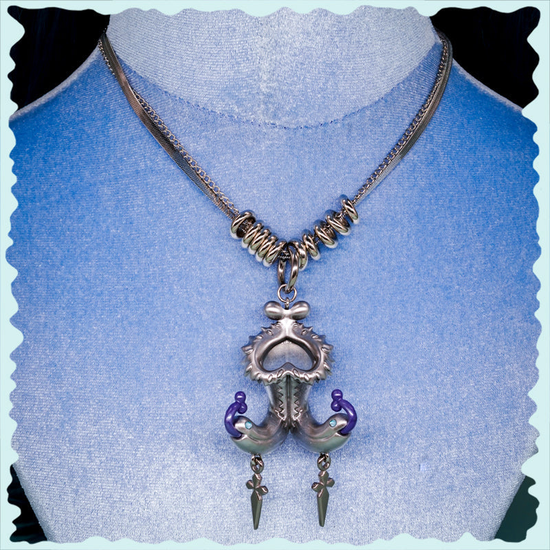 Twin-headed pitcher serpent earrings with violet tendrils and metallic spikes on silver-toned body