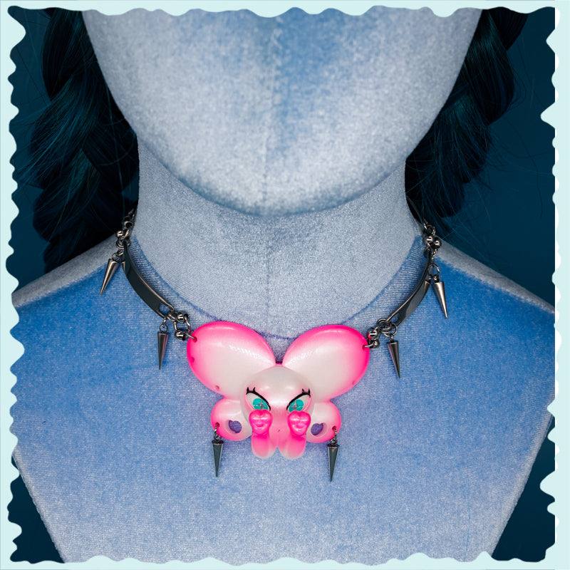 Twin-Trunk Diva Elephant Necklace with Bubblegum Pearl and detailed snake bowtie accessory