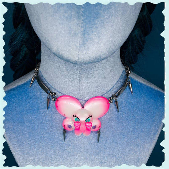 Twin-Trunk Diva Elephant Necklace with Bubblegum Pearl and detailed snake bowtie accessory